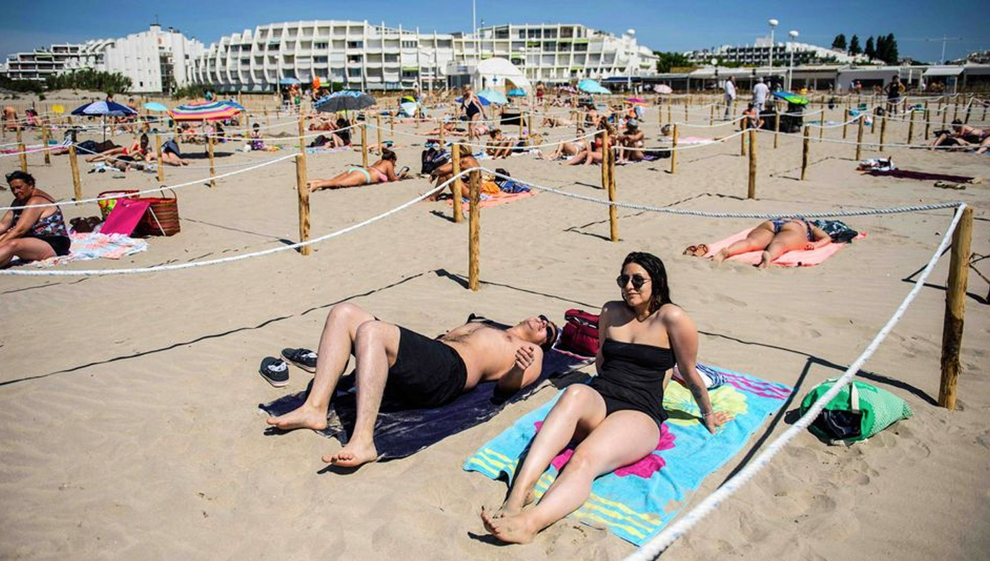 March 2020 | South of France | People sunbathe in a fenced area